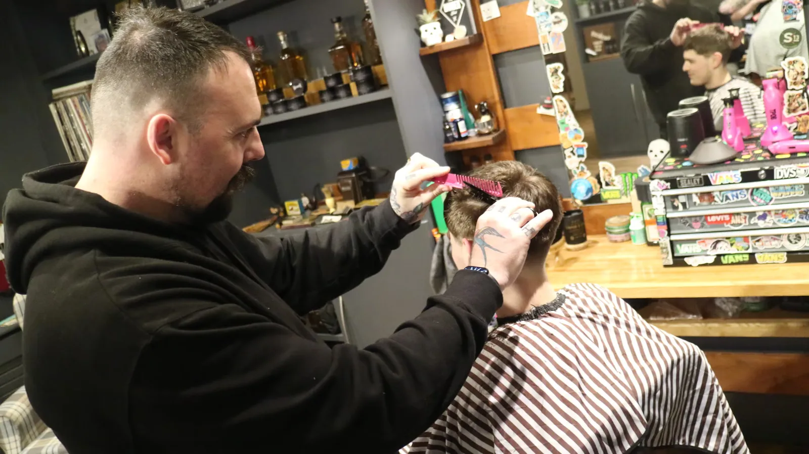 Cutting a younger client in a busy shop